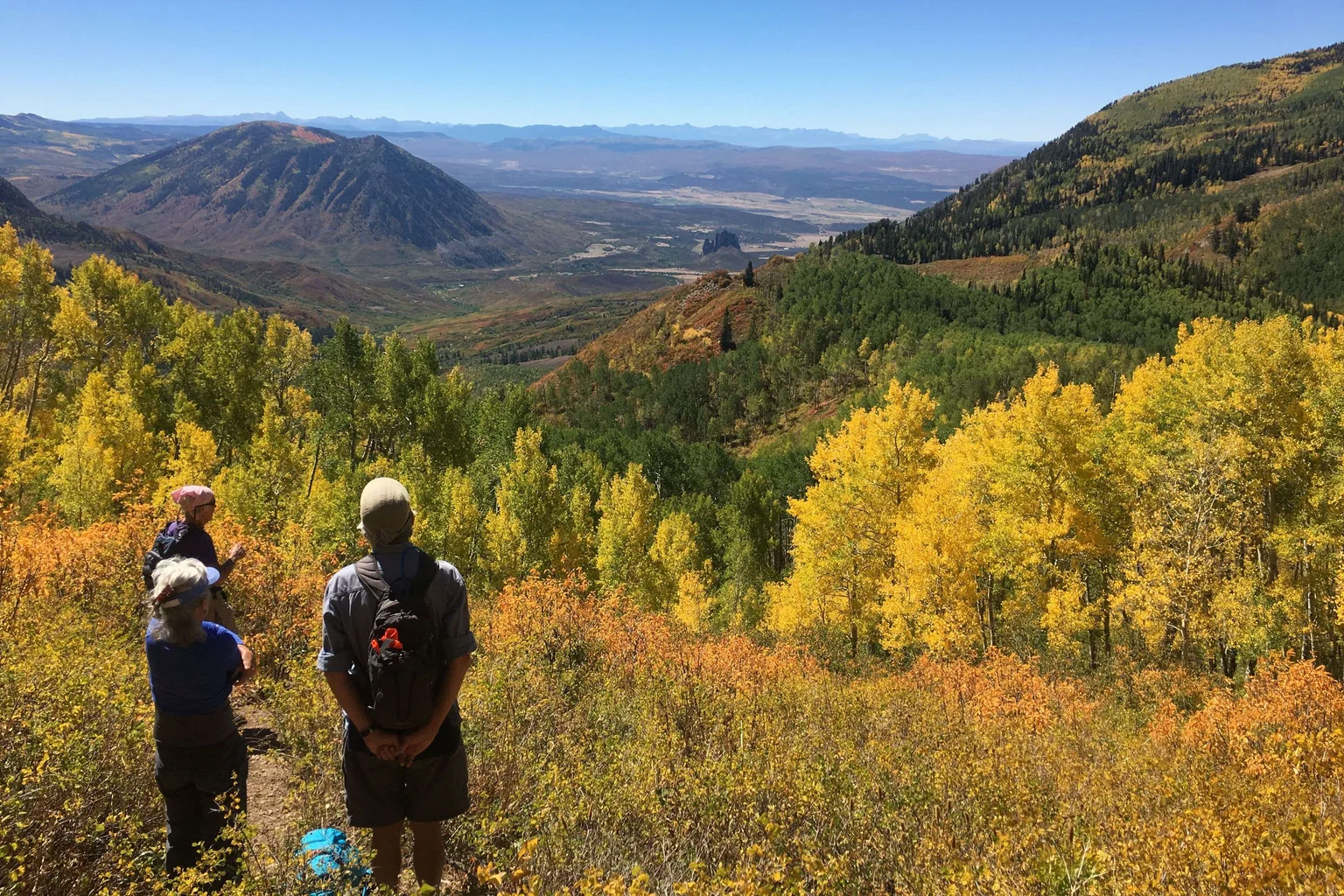 Hikers looking across the North Fork Valley from the Lamborn trail amid golden autumn foliage; photograph supplied by David Noe