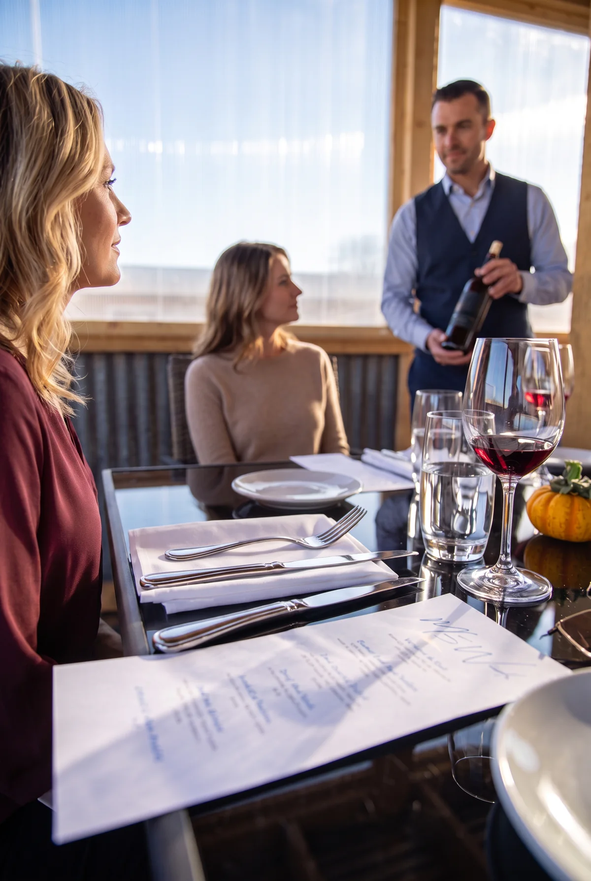 Guests listening as a host presents a bottle during a guided wine tasting
