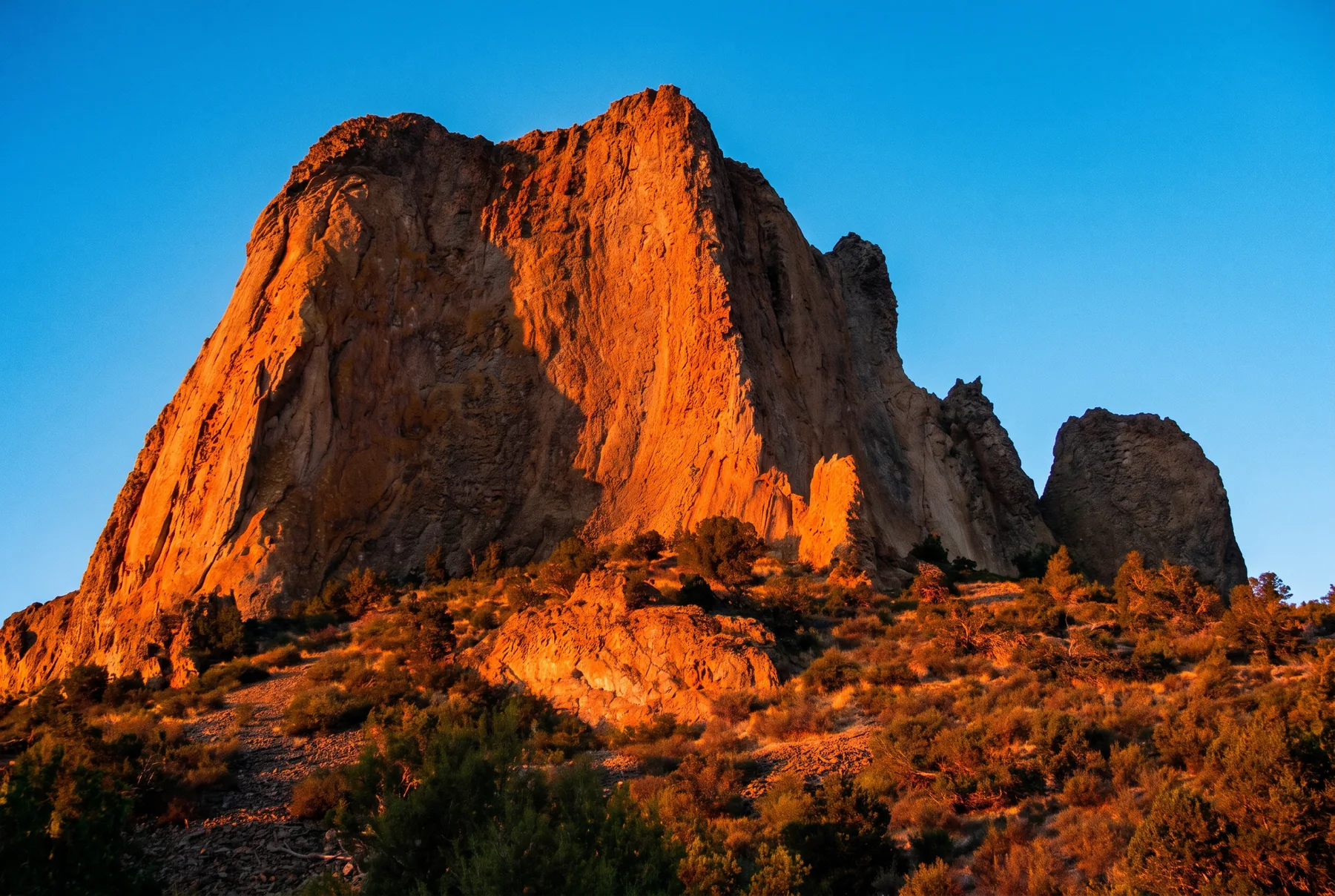 Warm sunlight across a red rock formation in Western Colorado